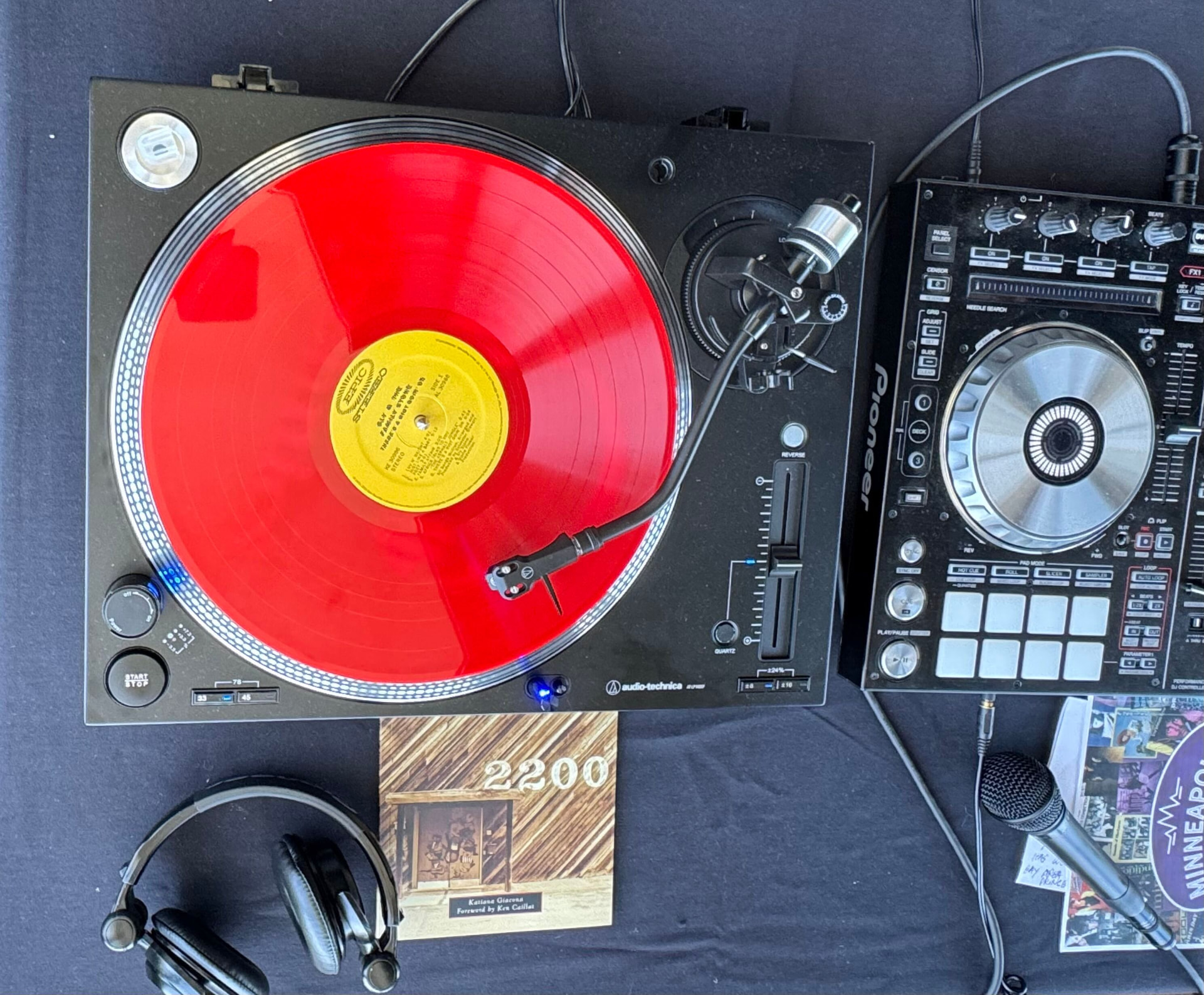 Katiana Giacona's setup: Audio-Technica turntable with her Record Plant book propped beside it, Pioneer mixer, headphones.