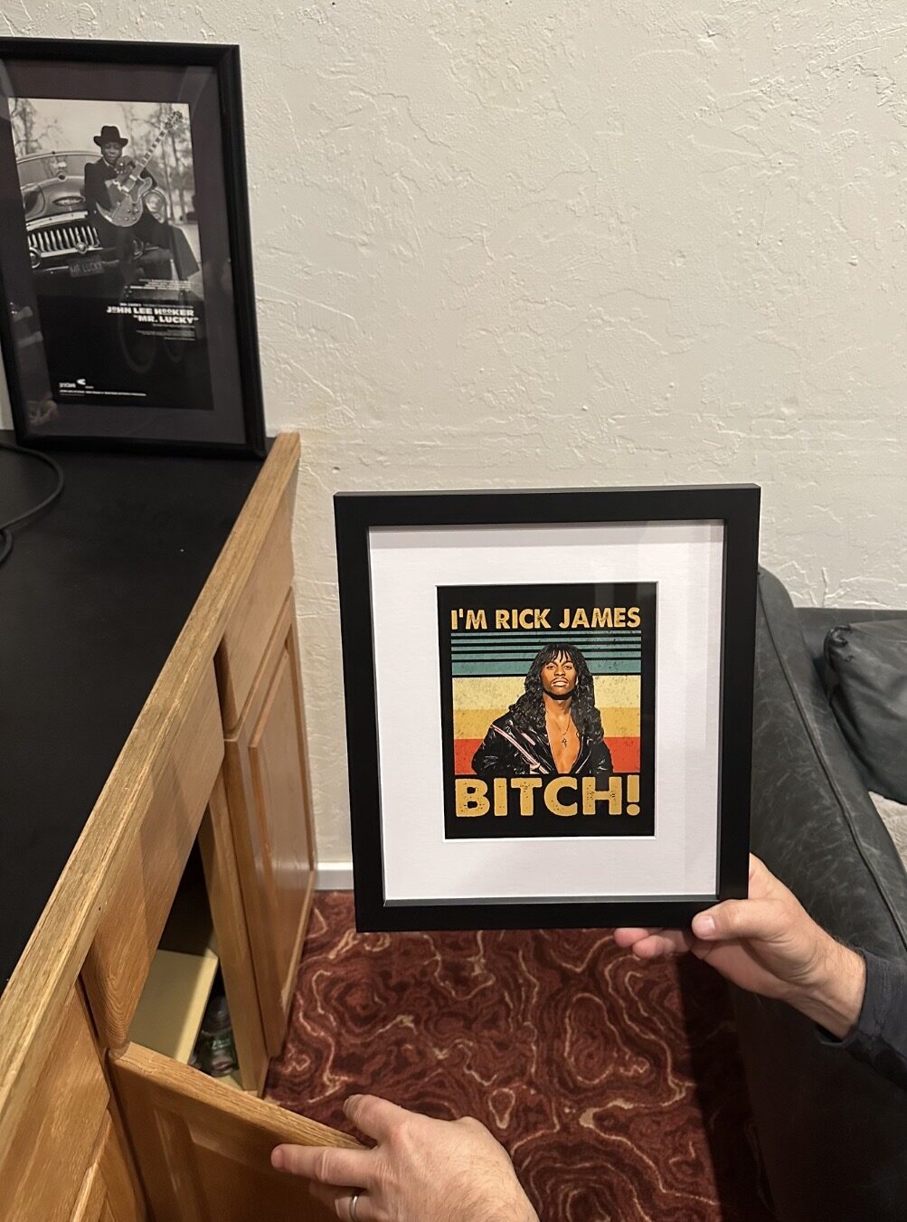 Cabinet inside the Rick James room with handwritten 'bitch' scrawled on it.