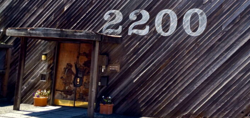The hand-painted '2200' address above the redwood-clad entrance at 2200 Bridgeway, Sausalito.