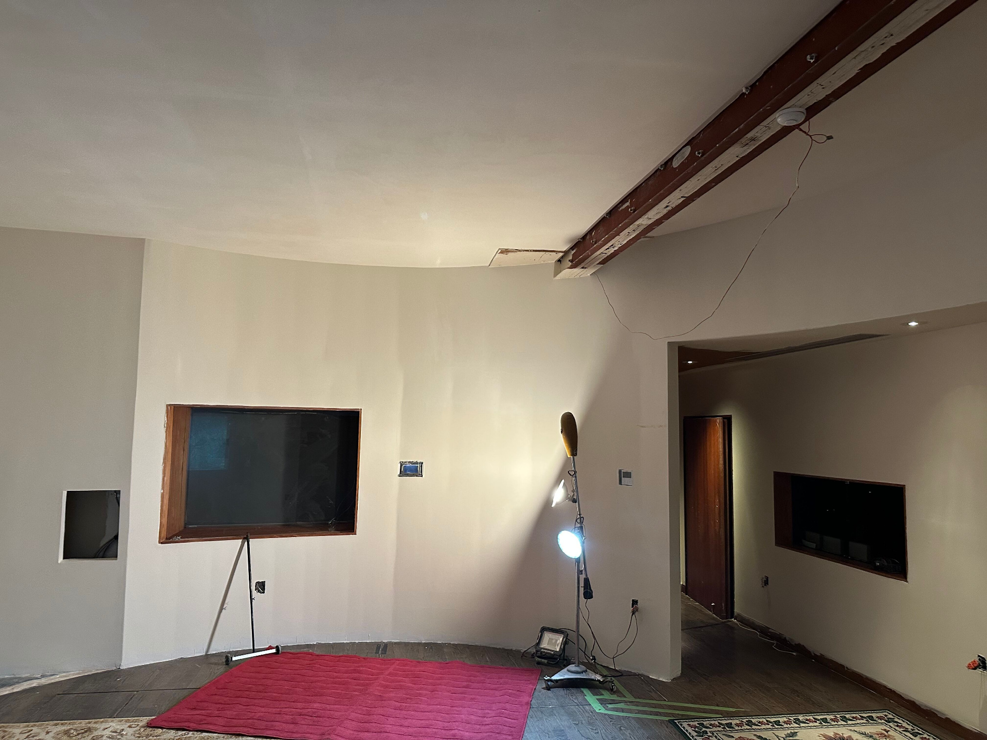 The Garden Studio mid-renovation, curved wall with control room window and exposed ceiling beam