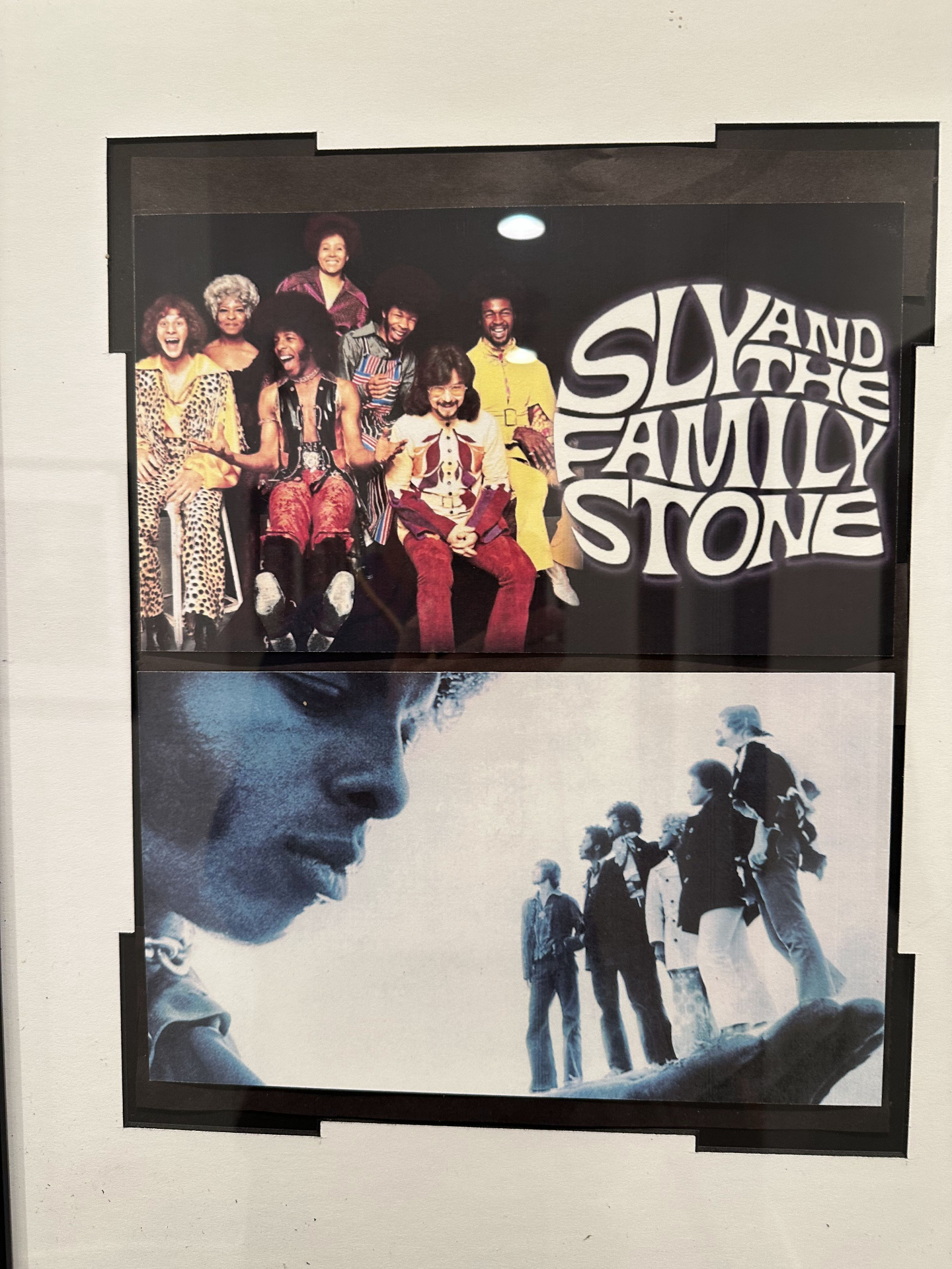 Sly and the Family Stone poster hanging in the studio — band portrait above a tinted Sly Stone photo.