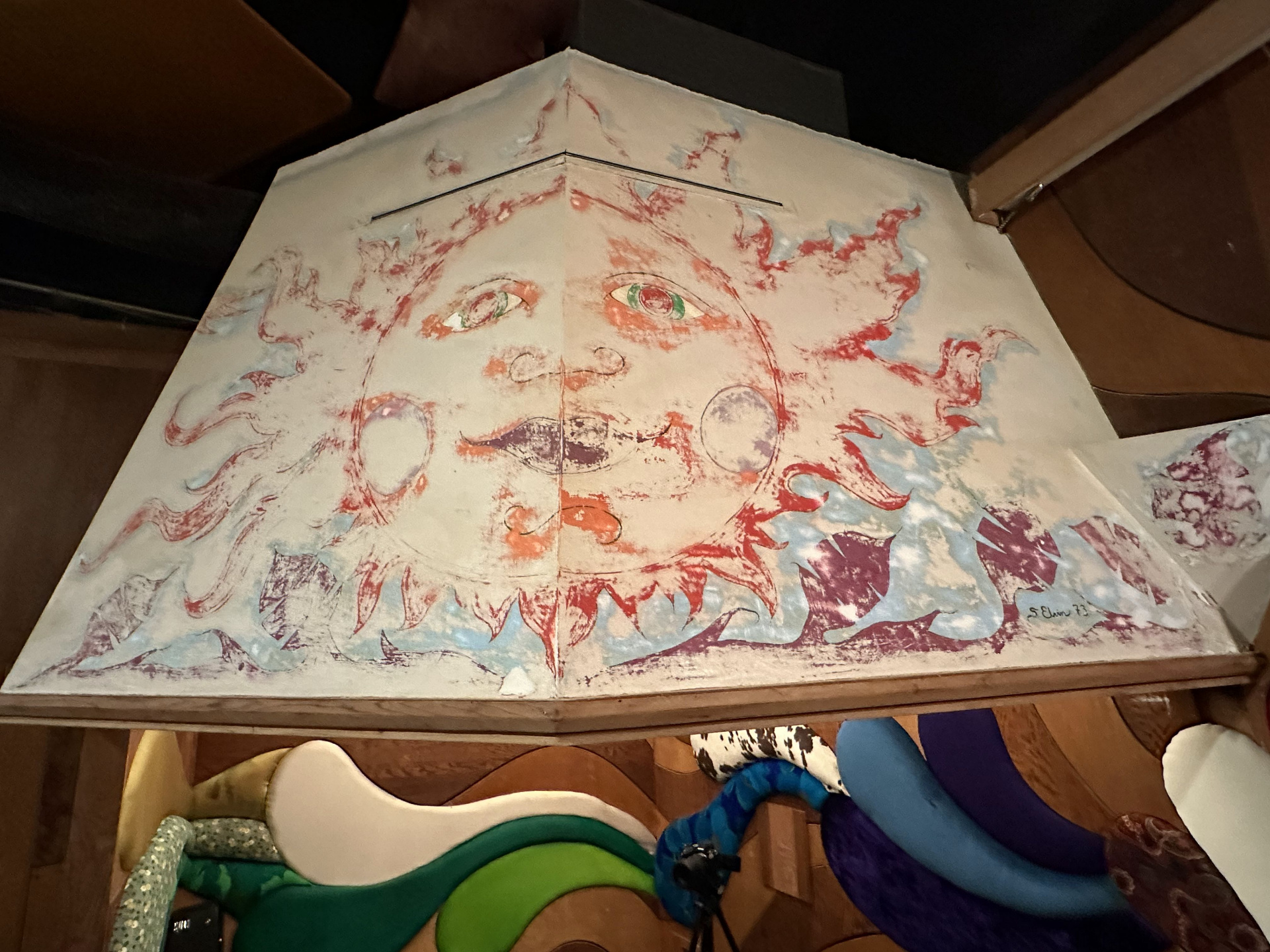 Painted sun-and-moon ceiling panel above the curved seating in Studio B, signed S. Elvin '73.